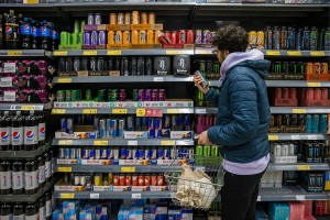 Man Shopping For Energy Drinks (Getty Images/SolStock)