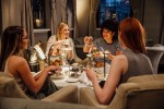 Four women are sitting together enjoying afternoon tea. (Getty Images/DGLimages)