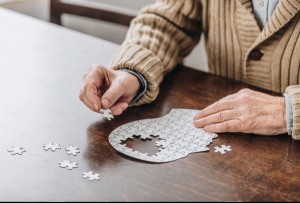 Senior man playing with puzzle (Getty Images/LightFieldStudios)