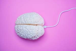Human brain connected with USB wire cord (SerrNovik (Getty Images))