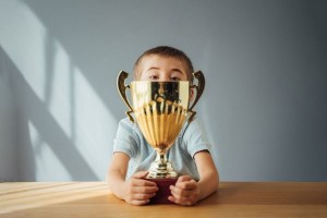 Child with trophy (Getty Images/Pofuduk Images)