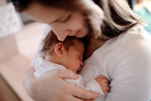 Mother holding a newborn baby (Getty Images/Halfpoint Images)