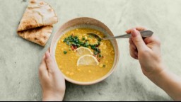 bowl of lentil soup garnished with lemon slices