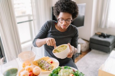 woman eating vegan food at home