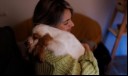 Woman hugging scared dog
