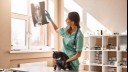 vet with a cat holding up an x-ray