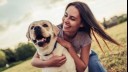 Owner hugging her yellow labrador