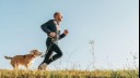 man and dog running cross country