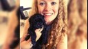 Woman holding a puppy yorkiepoo