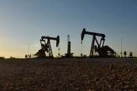 Oil prices at 2-1/2 month lows as China data offset supply cuts