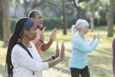 seniors practicing tai chi in park