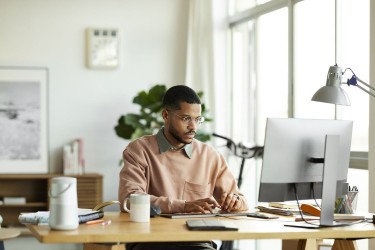 Man sitting at a desk working on the computer