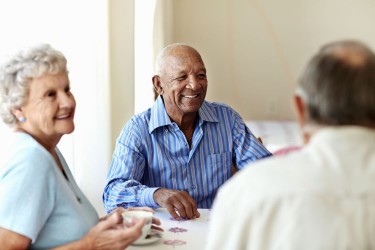 Older man having coffee with friends