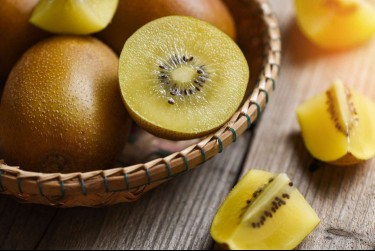 Sungold kiwi on wooden background