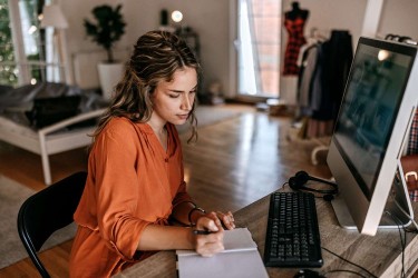 Young woman making a to do list