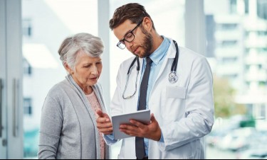 Doctor talking to an elderly female patient