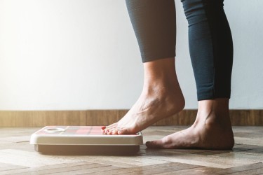 Woman stepping on scale