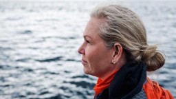 An older woman gazes out on the ocean