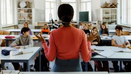 A teacher speaks to an elementary school classroom