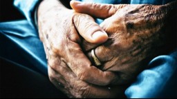 close-up of clasped hands with wrinkled skin