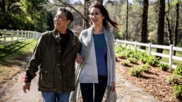 younger Asian woman and older Asian woman walking together outdoors