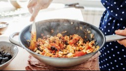 Tofu and vegetables cooking in a skillet