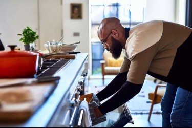 Man taking something out of the oven