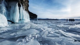 photo of permafrost with minivan and human silhouette in the background