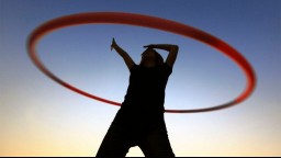 Silhouette of a female with a hula hoop