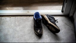 Muddy running shoes on a doorstep