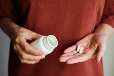 Woman taking a supplement