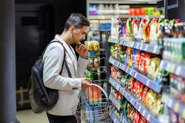 Man looking at snacks at the grocery store