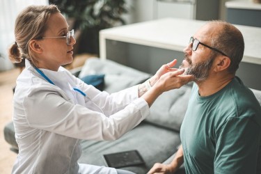 Doctor examines person in their office.