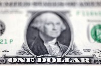 Dollar dips ahead of PMI data releases from major economies